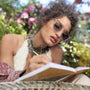 Woman with sunglasses outside writing